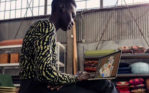 A person sitting on a chair using a computer

Description automatically generated